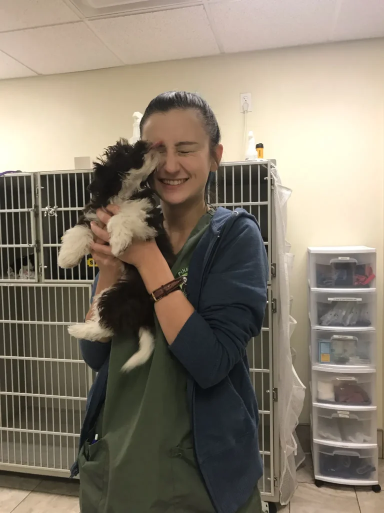 Owner preparing a puppy for vaccination at a friendly veterinary clinic